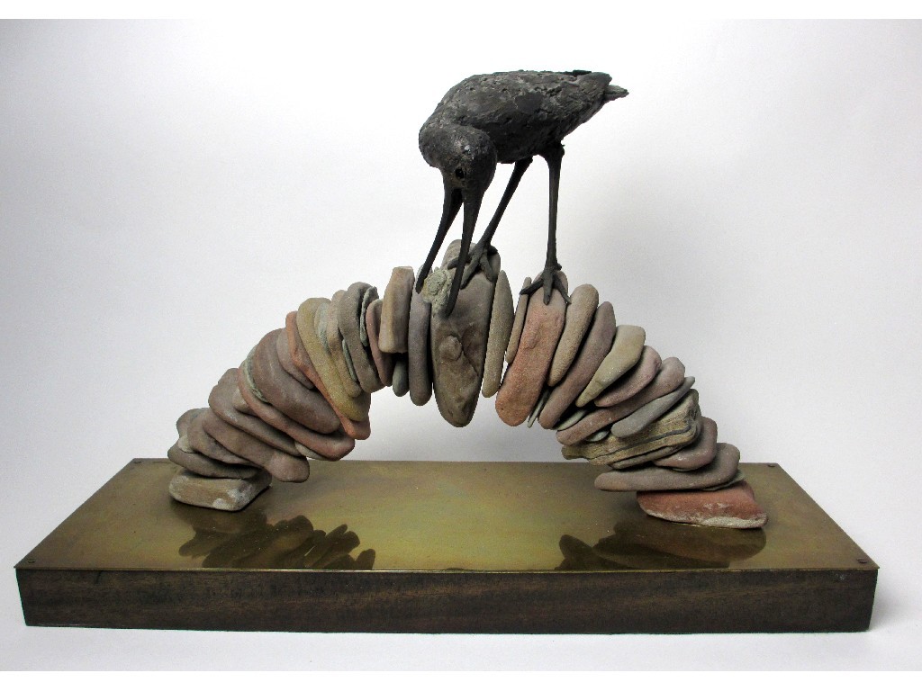 Appraisal: A bronze model of a bird standing on a pebble