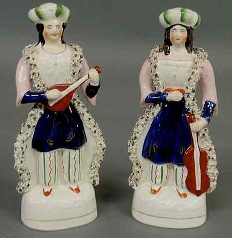 Appraisal: Pair of th c Staffordshire standing musicians a man and