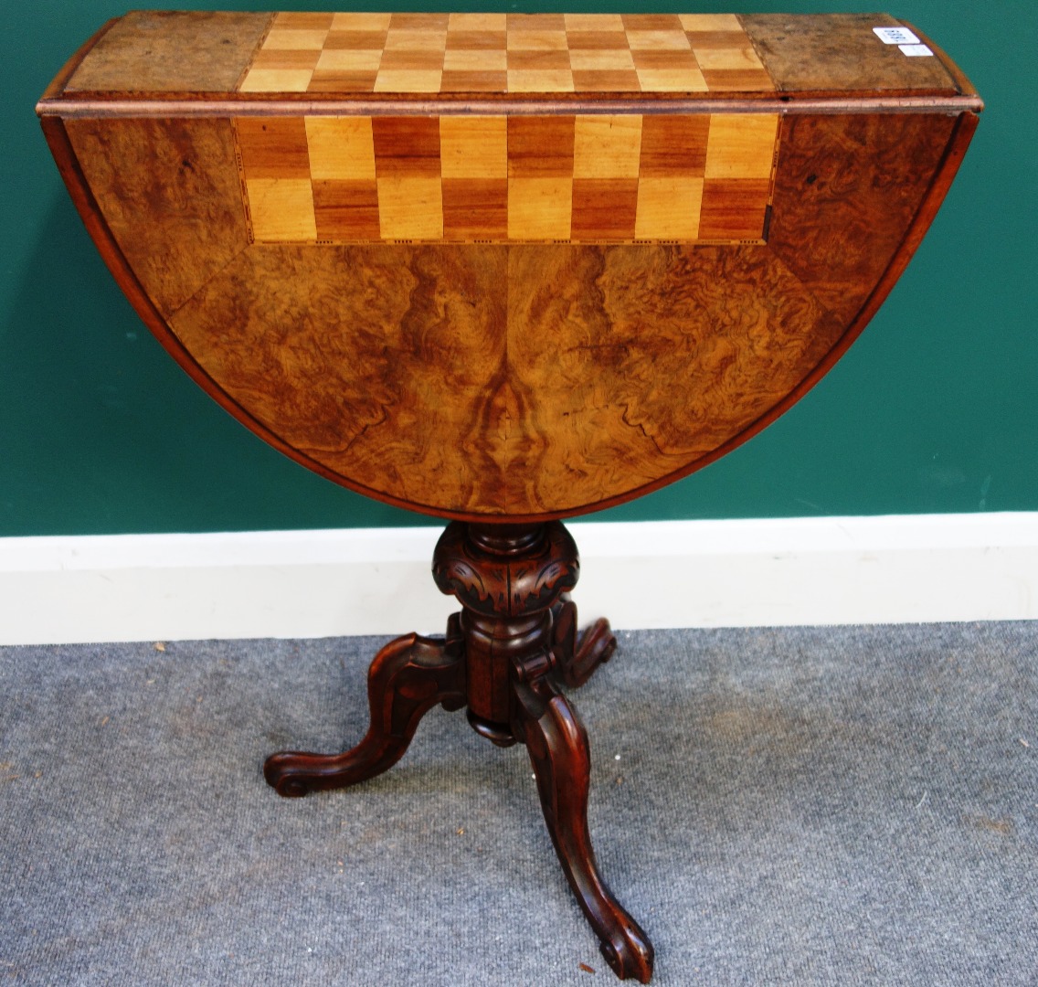 Appraisal: A Victorian figured walnut drop flap games table on carved