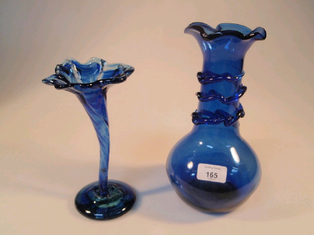 Appraisal: A blue tinted glass vase of compressed circular form with