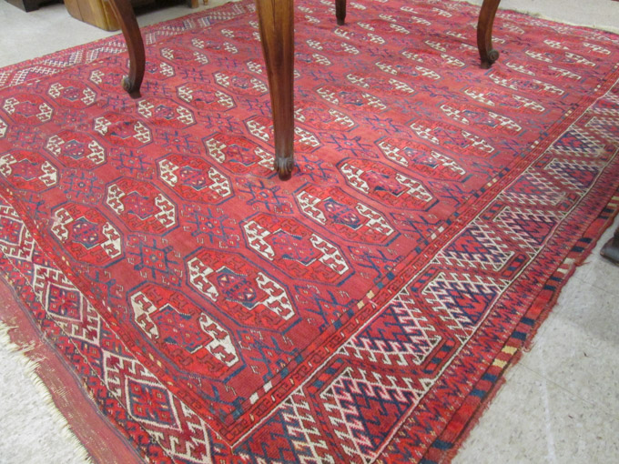 Appraisal: SEMI-ANTIQUE PERSIAN TURKOMAN BOKHARA CARPET Bokhara design of repeating octagonal