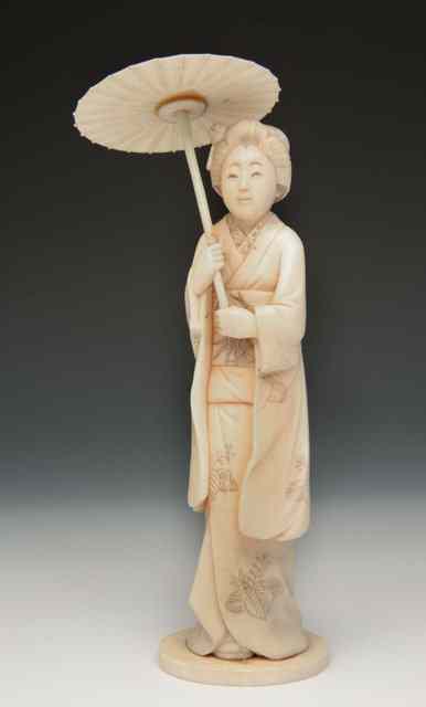 Appraisal: A JAPANESE IVORY OKIMONO of a standing figure of a