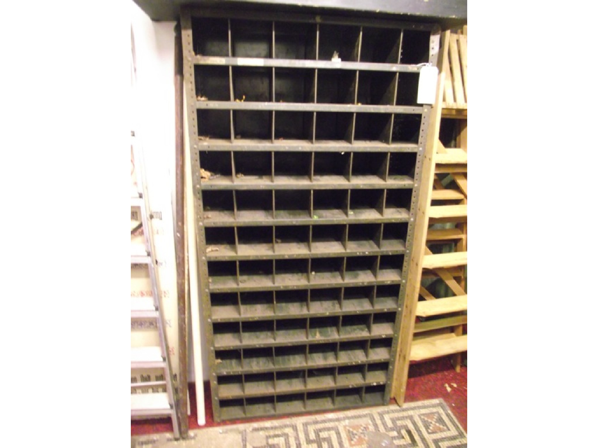 Appraisal: An industrial steel freestanding flight of pigeon holes with original