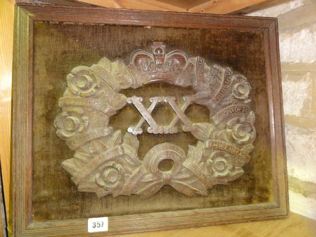 Appraisal: An oak carved military th anniversary emblem in the form