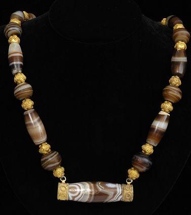 Appraisal: EARLY PERSIAN AGATE AND GOLD BEAD NECKLACE in central pendant