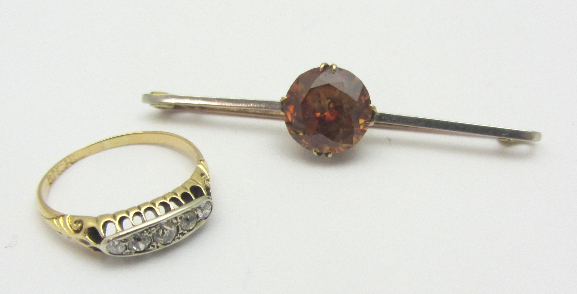 Appraisal: A gold and platinum brown zircon set single stone bar