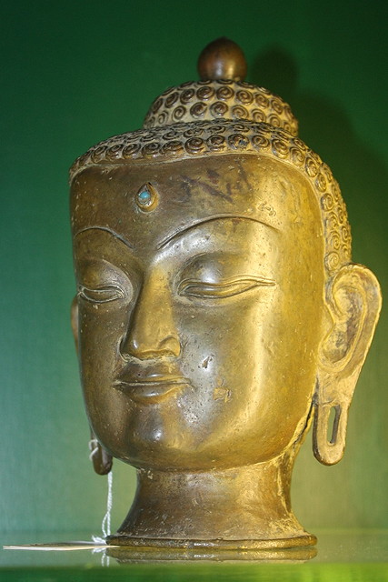 Appraisal: A SINO TIBETAN BRONZE DEITY HEAD with inset turquoise cm