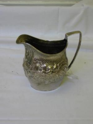 Appraisal: A GEORGE III CREAM JUG of helmet form with flattened