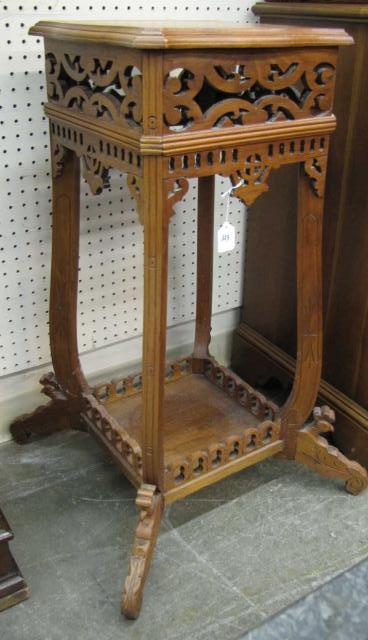 Appraisal: Antique ornately-carved fern stand with bottom shelf rooster motif carved