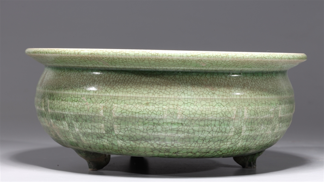 Appraisal: Chinese celadon glazed tripod censer with molded designs to body