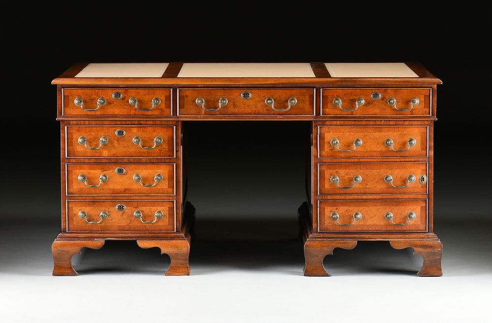 Appraisal: A GEORGE II STYLE WALNUT CREAM LEATHER TOP PARTNER'S DESK