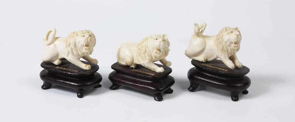 Appraisal: PIECE SINGAPORE CARVED IVORY LIONS Two with raised tails other