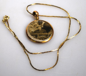 Appraisal: Gilt metal open style locket containing vintage photographs on ct