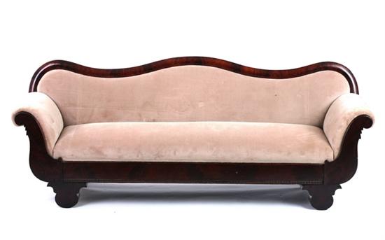 Appraisal: VICTORIAN PILLAR AND SCROLL FLAME MAHOGANY SOFA th century Serpentine