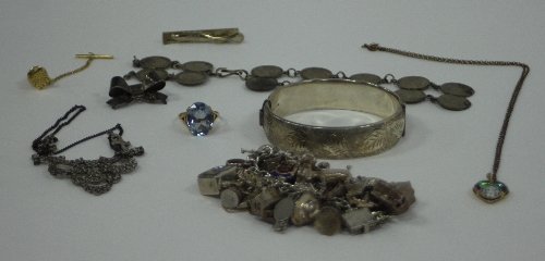 Appraisal: A silver charm bracelet with a variety of charms including