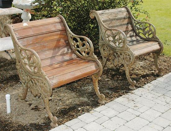 Appraisal: Pair cast-iron and wood garden seats scrolling side supports unified