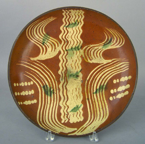 Appraisal: Redware charger th c with yellow and green slip decoration