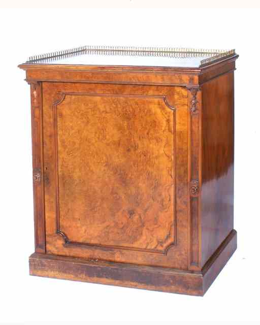 Appraisal: A VICTORIAN WALNUT PIER CABINET with pierced brass gallery and