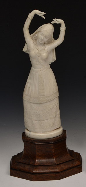 Appraisal: AN EASTERN IVORY FIGURE carved in the form of a