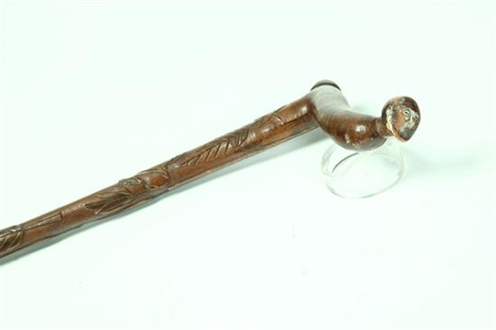 Appraisal: FOLK ART CANE American maple Crook handle with stylized faces