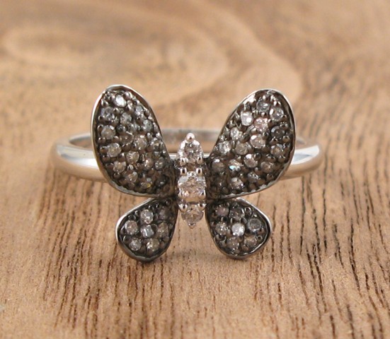 Appraisal: DIAMOND AND FOURTEEN KARAT GOLD RING The white gold butterfly