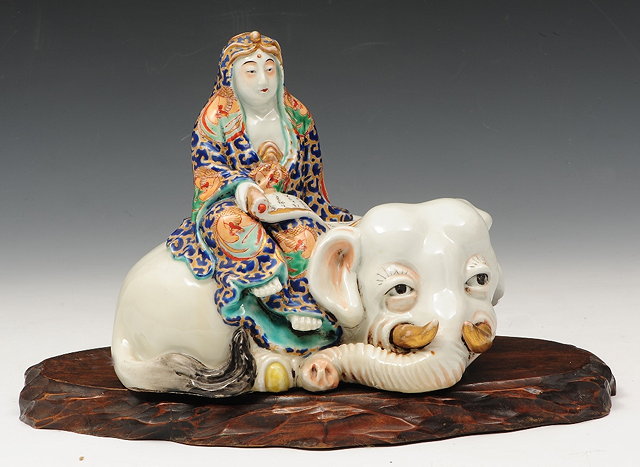 Appraisal: A JAPANESE KUTANI PORCELAIN MODEL of a figure reading a