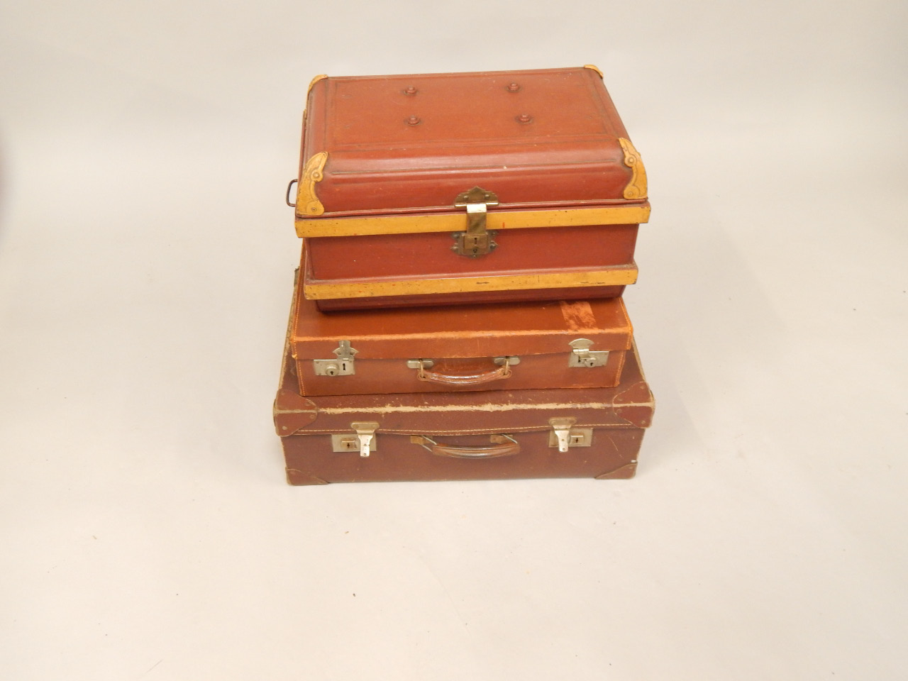 Appraisal: A tin trunk and two suitcases