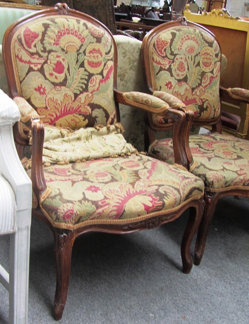 Appraisal: A pair of Louis XV style beech framed fauteuils with