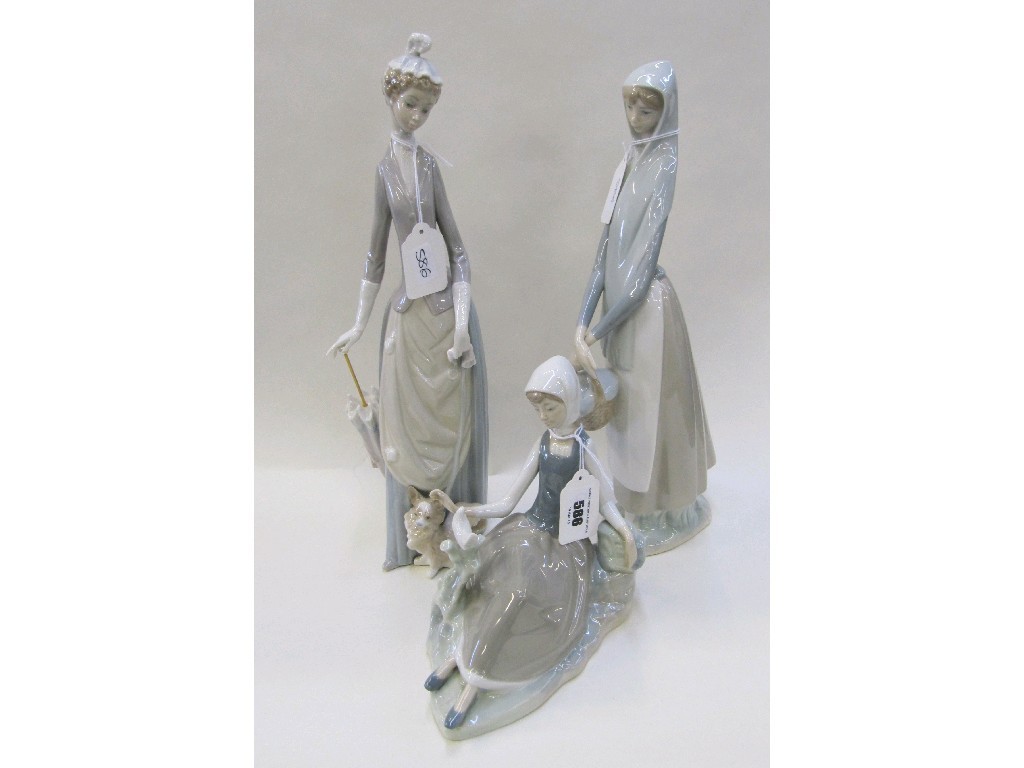 Appraisal: Three Lladro figures to include a woman walking a dog