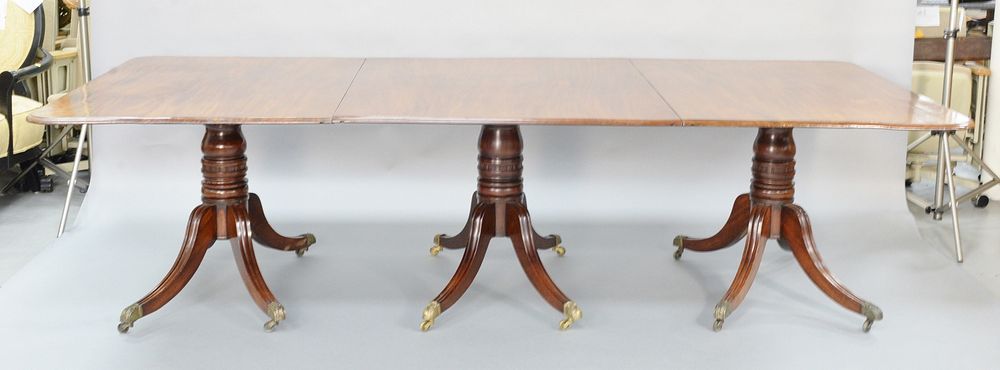 Appraisal: George III mahogany triple pedestal dining table having two leaves