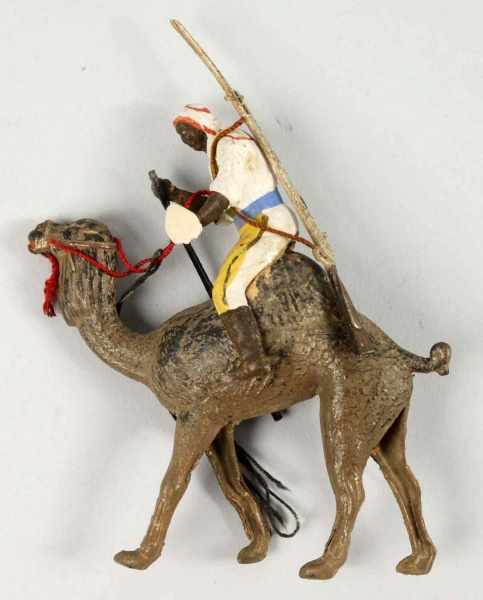 Appraisal: Dresden Man Riding Camel Christmas Ornament Description Some minor wear