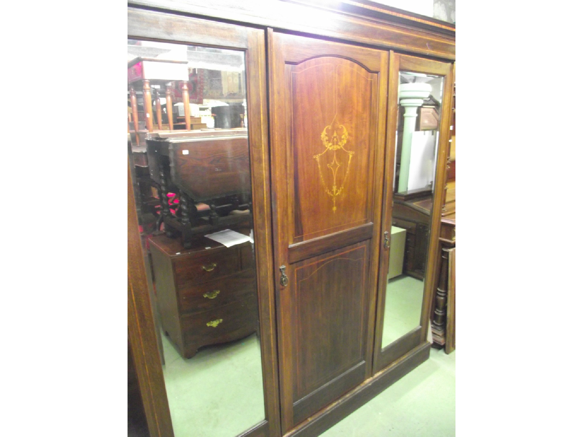 Appraisal: An inlaid Edwardian mahogany triple wardrobe with satinwood crossbanding and