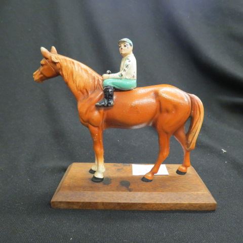 Appraisal: Hubley Cast Iron Figurine of Jockey on Horse wooden base