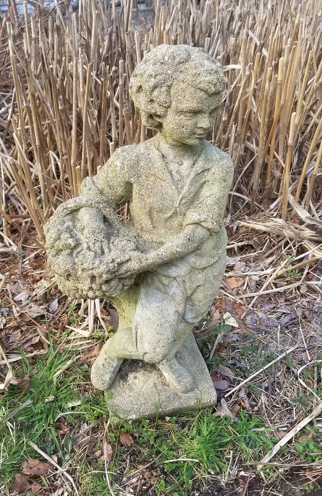 Appraisal: Poured Cement Figure of a Young Boy Holding a Fruit