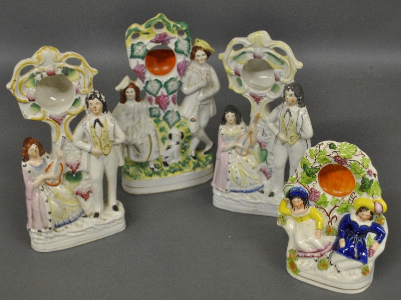 Appraisal: - Four th c Staffordshire figural group watch holders Largest