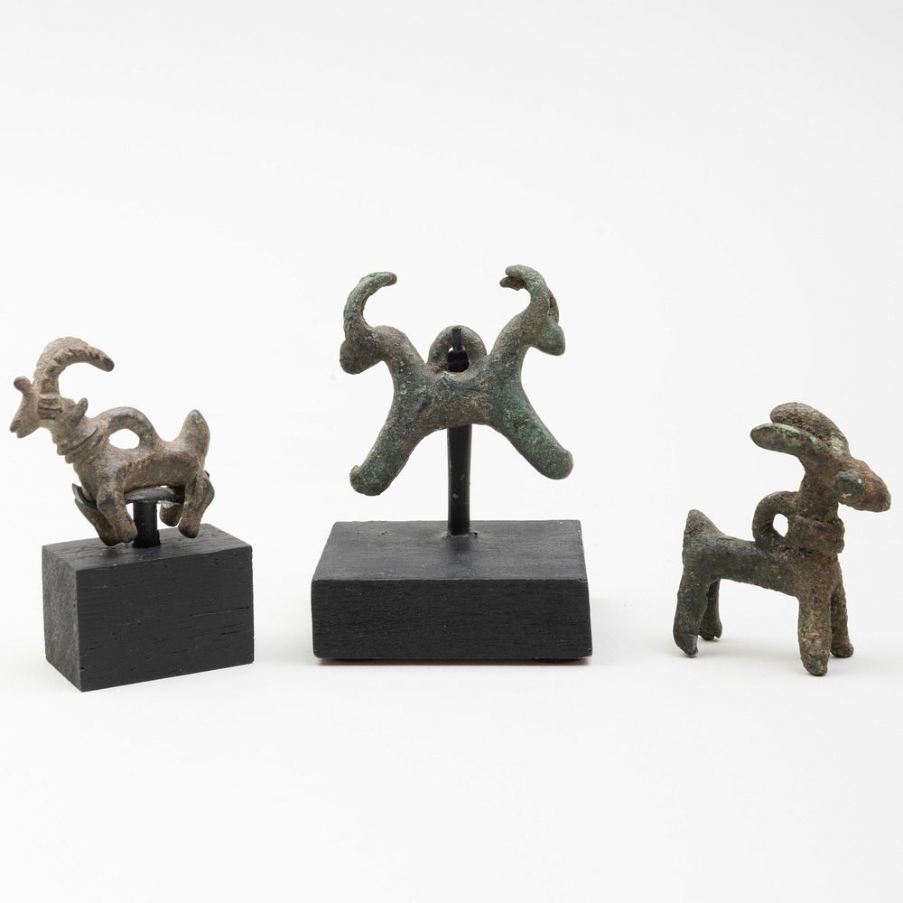 Appraisal: Group of Three Luristan Bronze Ibex Amulets Two raised on