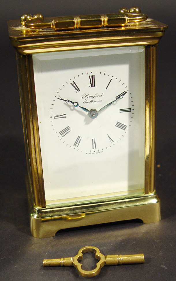 Appraisal: Brass carriage clock with bevelled glass panels and key retailed