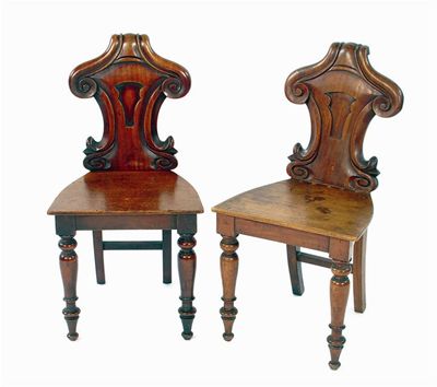 Appraisal: A pair of Victorian mahogany hall chairs having shaped moulded