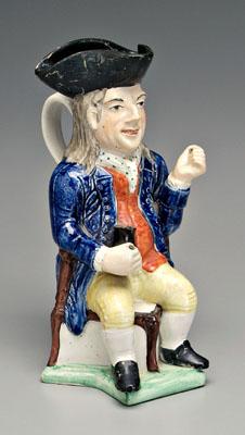 Appraisal: Toby jug gentleman seated on corner chair and wearing tricorn