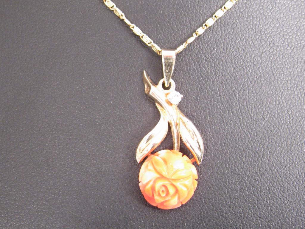 Appraisal: A Continental Coral and Diamond Pendant the carved coral rose