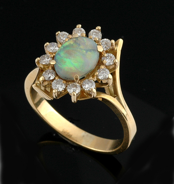 Appraisal: A SOLID WHITE OPAL AND DIAMOND CLUSTER RING The oval