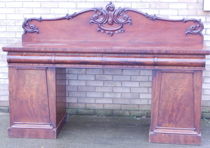 Appraisal: An early Victorian mahogany pedestal sideboard the raised back carved