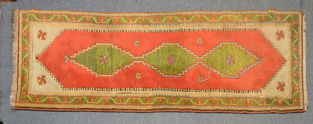 Appraisal: A TURKISH RED GROUND RUNNER with central apple green inter-linked