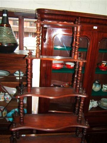 Appraisal: A Victorian walnut five tier whatnot with serpentine shaped shelves