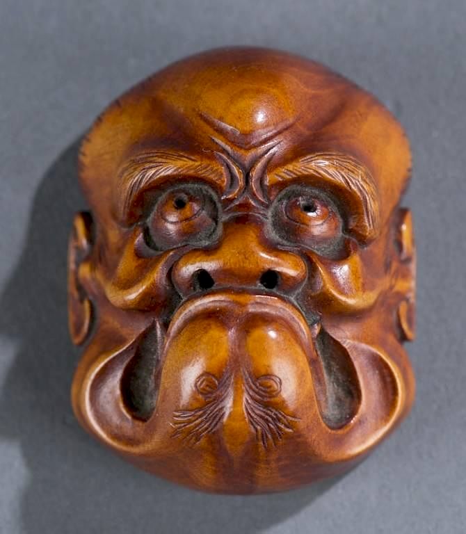 Appraisal: Japanese wood mask netsuke A Japanese wood mask netsuke signed