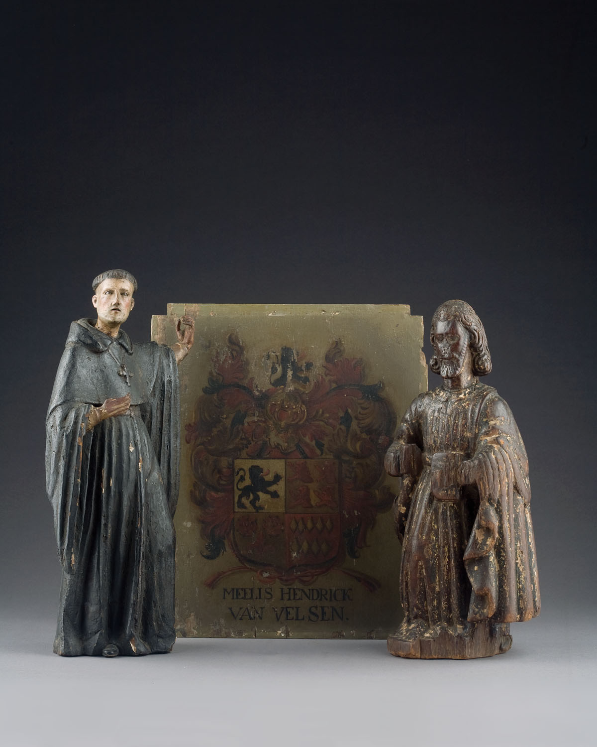 Appraisal: TWO CONTINENTAL CARVED AND PAINTED SANTOS FIGURES Each robed one