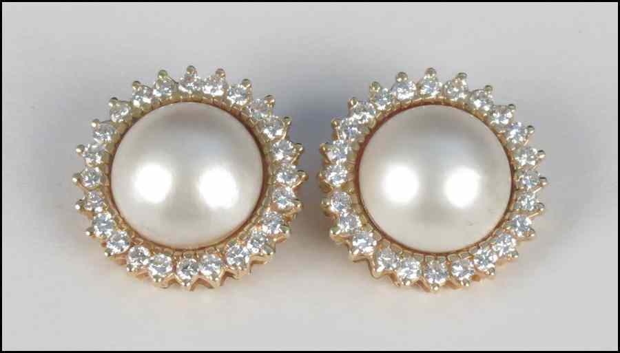 Appraisal: PAIR OF MABE PEARL DIAMOND AND GOLD EARCLIPS Pearls are