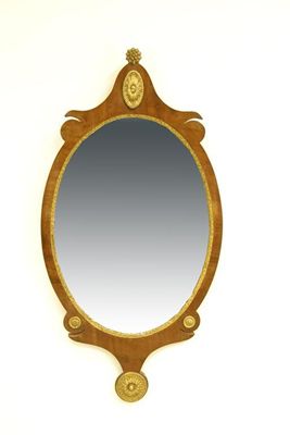 Appraisal: A continental mahogany and parcel gilt oval wall mirror th