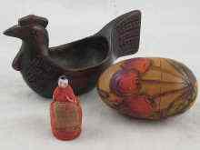 Appraisal: A Russian wooden egg with pokerwork and stain decoration containing