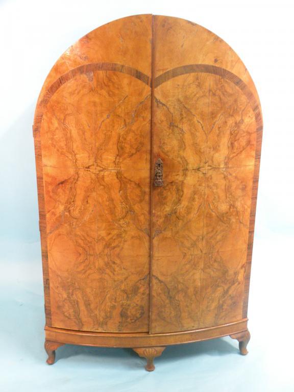 Appraisal: A small walnut dome-top wardrobe in Art Deco style with